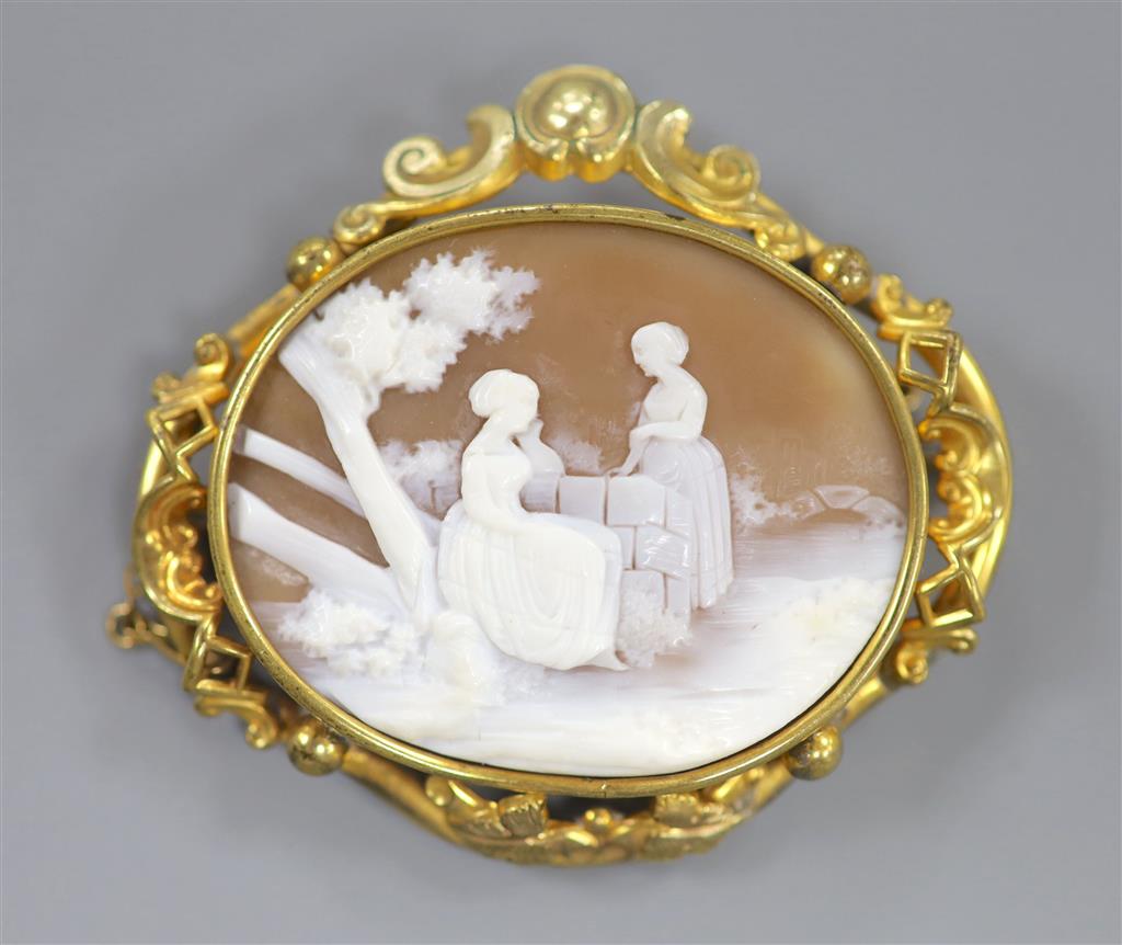 A Victorian pinchbeck mounted oval cameo shell brooch, carved with figure in a garden, 57mm.